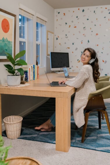 Jasmine sitting at the desk with her computer working