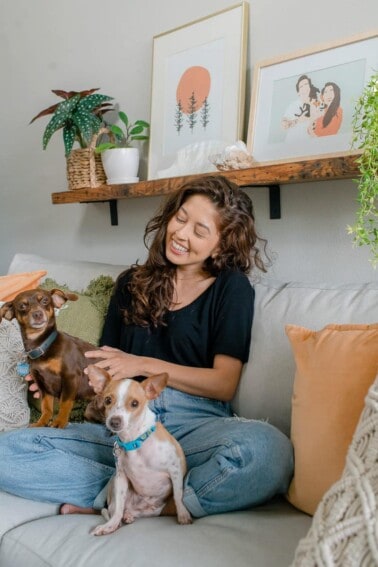 Girl named Jasmine sitting on couch with the dogs