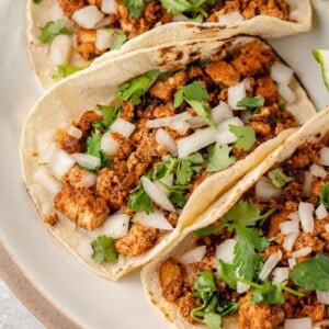 close up photo of tofu taco meat in tortilla