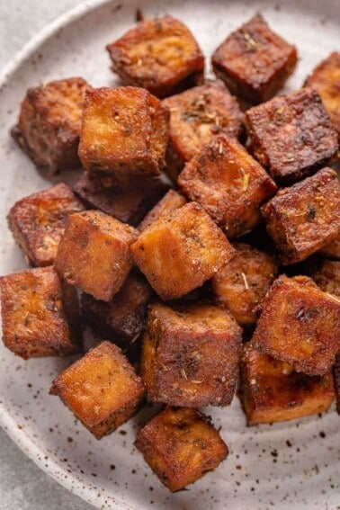 overhead image of crispy air fryer herbed tofu on a plate