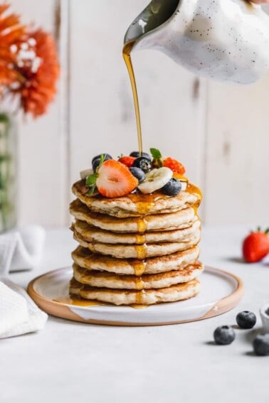 action shot of pouring syrup on Fluffy Buttermilk Pancakes