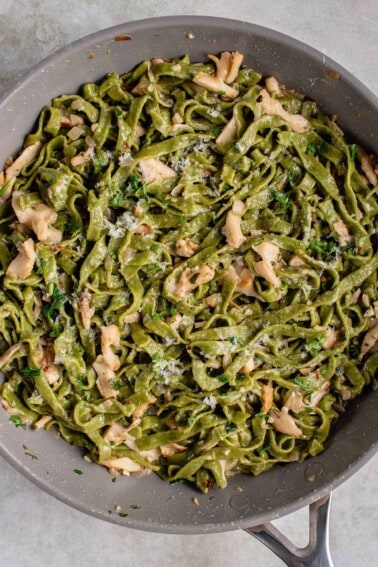 fresh spinach pasta in pan with mushroom butter sauce