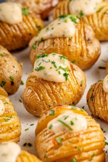 vegan sour cream and onion hasselback potatoes on plate