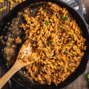 overhead image of skillet of one pot vegan hamburger helper with spoon