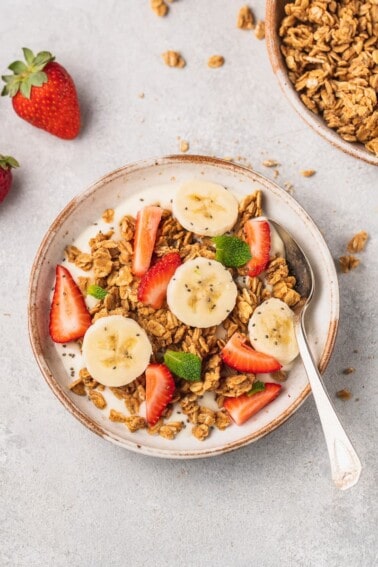 overhead image of yogurt topped with granola and fruit