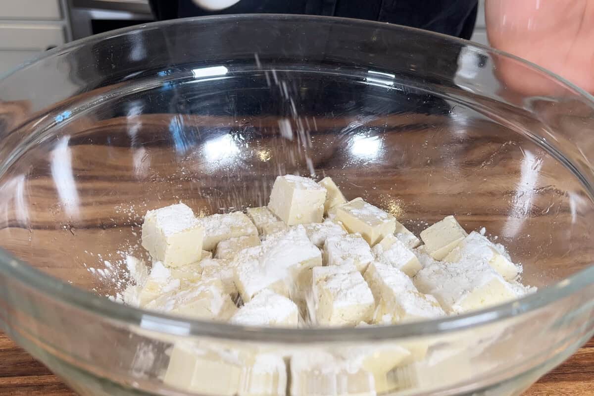 adding corn starch to bowl