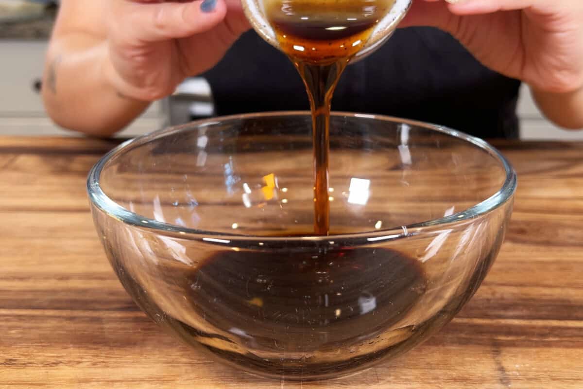 adding maple syrup to bowl