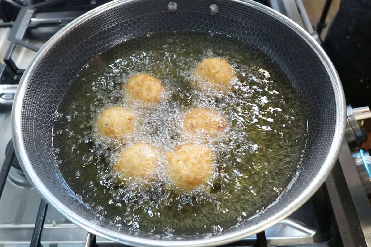 rice balls deep frying in oil