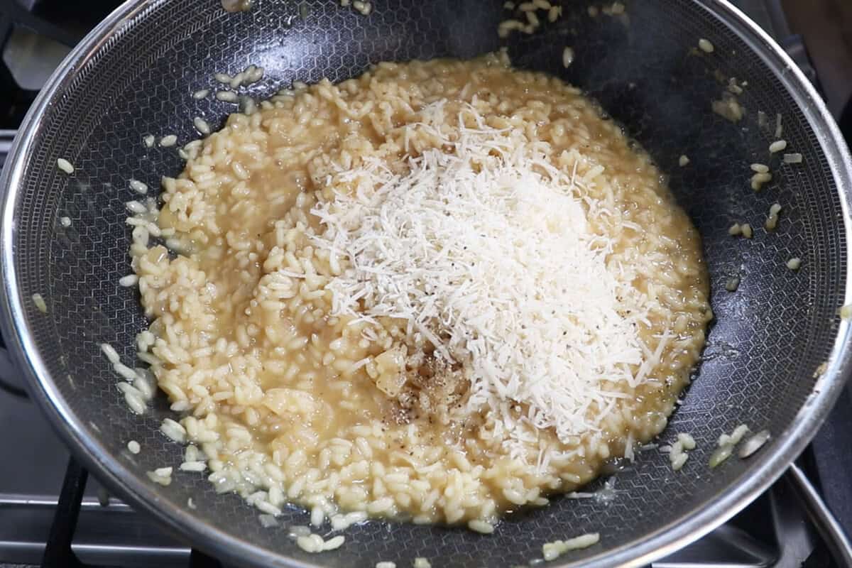 adding parm to risotto in a wok