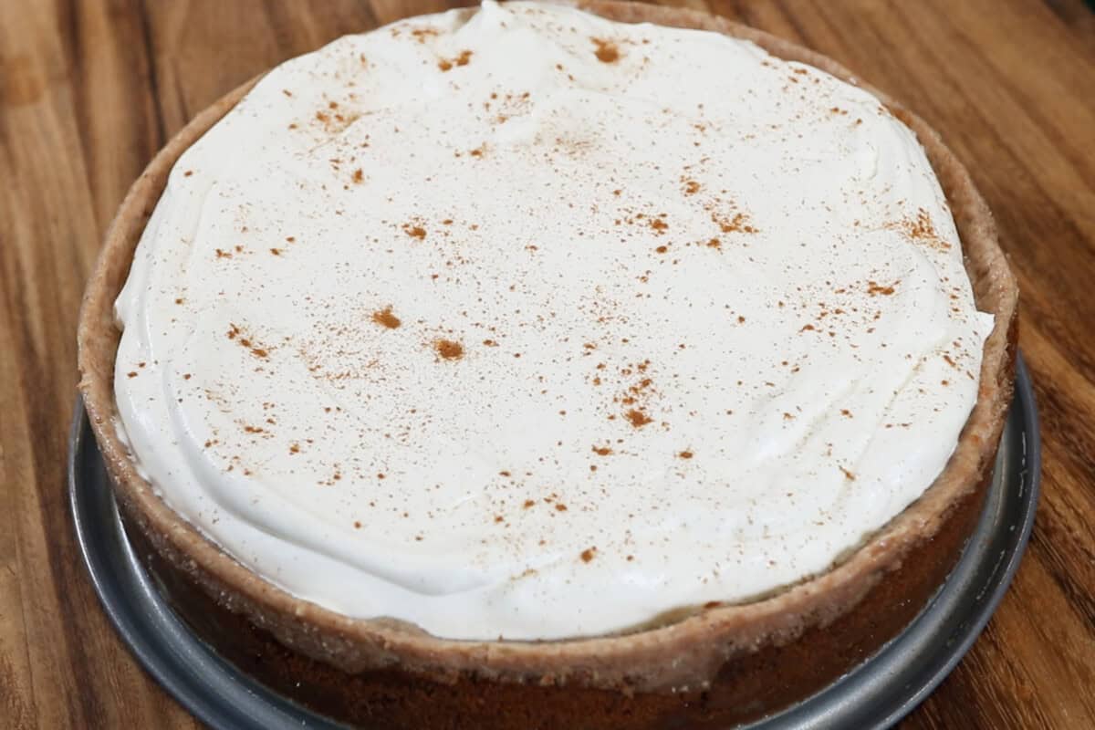 baked Vegan Chai Spiced Cheesecake with whipped cream and cinnamon