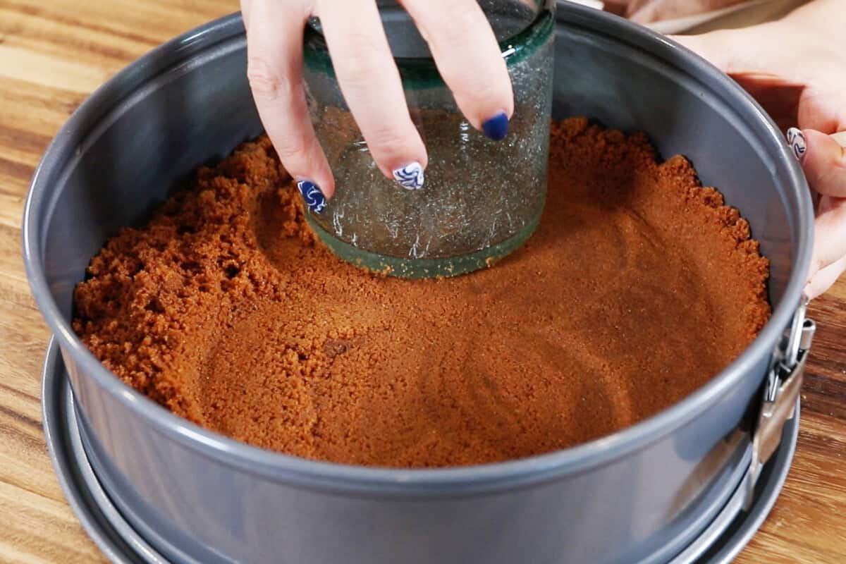 homemade biscoff crust in pan for cheesecake