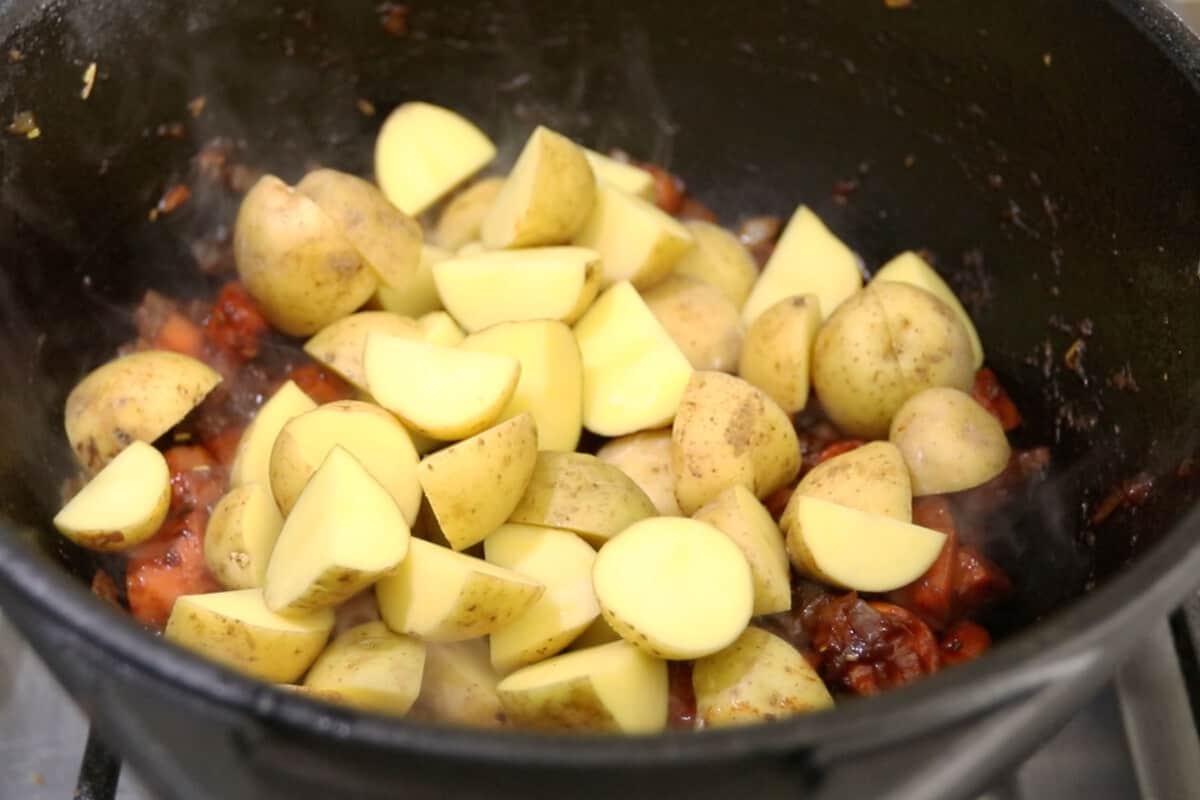 step by step - potatoes added on top of onions and carrots