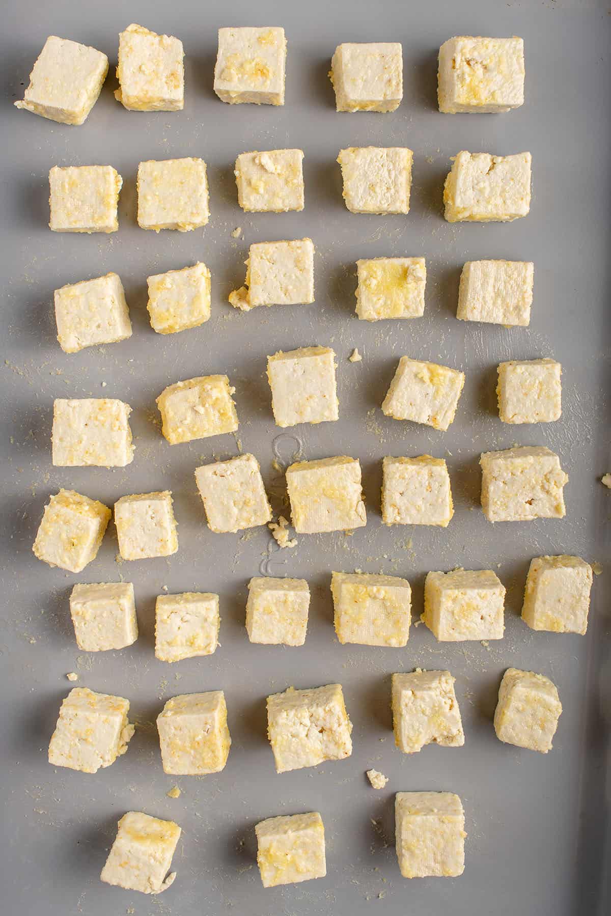 coated tofu on a baking sheet