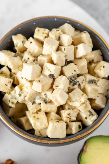 An easy and delicious vegan feta cheese that is made out of tofu and will make all of your dreams come true. This cheese swaps perfectly with its nonvegan counterpart and the possibilities for serving it are endless! #vegan #vegancheese #feta #easy #foolproof #salad #appetizer #side #avocadotoast #veganpasta #veganized #musttry