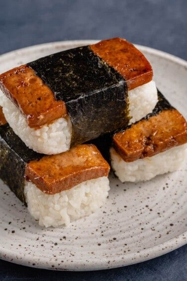 stack of tofu musubi on white plate