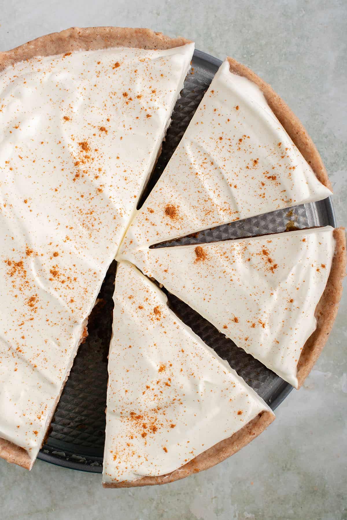 overhead photo of slices of chai spiced vegan cheesecake in pan