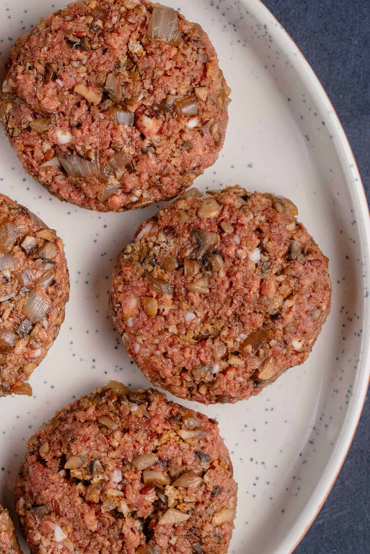 uncooked burger steak on a plate