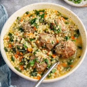 bowl of vegan italian wedding soup topped with parmesan