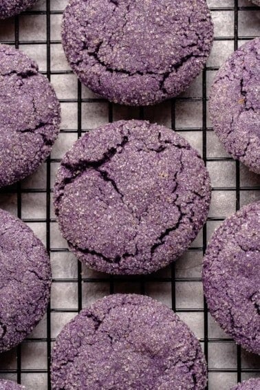 vegan ube sugar cookies on a black cooling rack