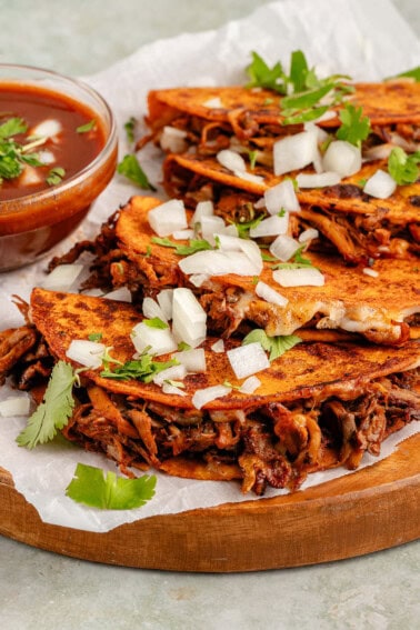 tacos with filling spilling out on wooden platter