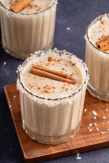 photo of vegan coquito with cinnamon sticks