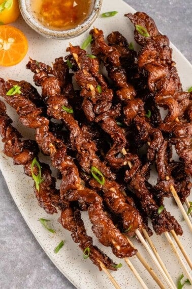 vertical photo of Vegan Filipino Barbecue on skewers with green onions