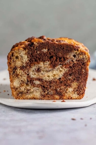 sliced marbled chocolate banana bread on a white plate