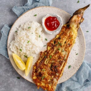 white plate with vegan tortang talong, rice and banana ketchup