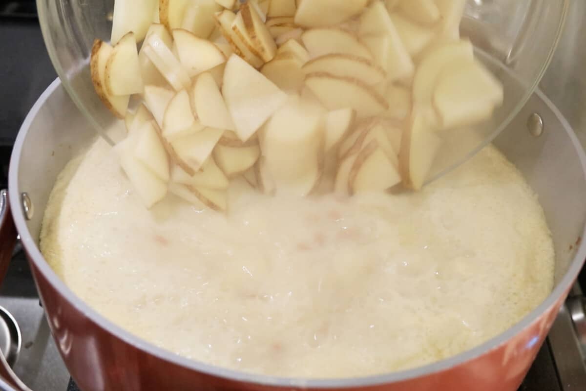 potatoes being added to pot